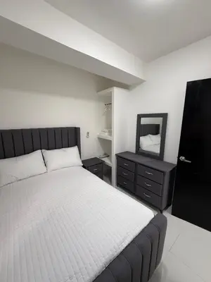 a bedroom with a large bed and a mirror at Moon Apartamentos D2 in San Cristóbal