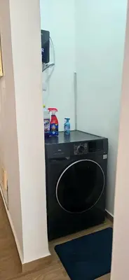 a black washer and dryer in a room at Brisa del Mar Punta Cana Apartment in Punta Cana