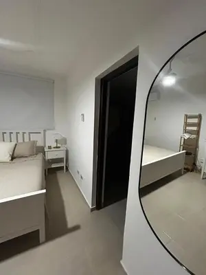 a room with a mirror and a bedroom with a bed at Residencial ambar lll in Santiago de los Caballeros