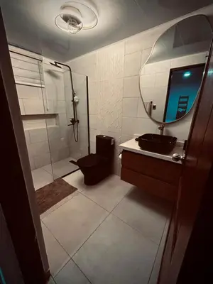 a bathroom with a shower and a sink and a mirror at Residencial ambar lll in Santiago de los Caballeros