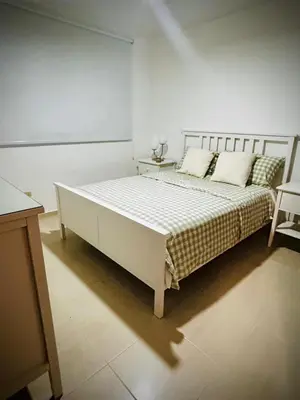 a bedroom with a large white bed with two pillows at Residencial ambar lll in Santiago de los Caballeros