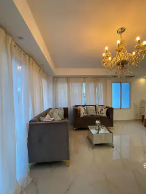 a living room with a couch and a chandelier at Departamento en la playa de palenque in Sabana Grande de Palenque