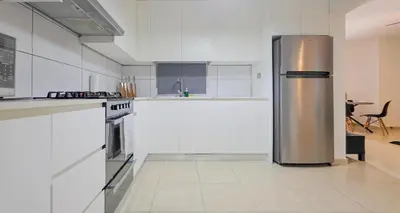 a large kitchen with a stainless steel refrigerator at Escapada Perfecta Piscina 5 Min a la Playa in Punta Cana