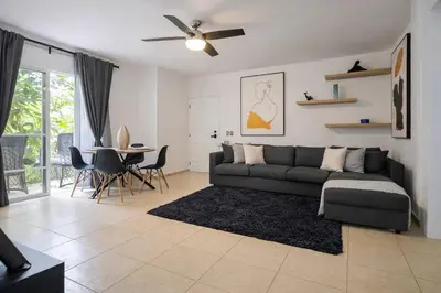 a living room with a couch and a table at Escapada Perfecta Piscina 5 Min a la Playa in Punta Cana