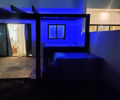 a dark room with blue lights on the wall at Pure relax in Bavaro La Casita de Giò in Punta Cana