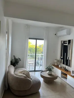 a living room with a chair and a table at Luz y paz