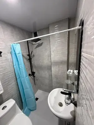 a bathroom with a shower and a toilet and a sink at Moon Apartamentos D3 in San Cristóbal