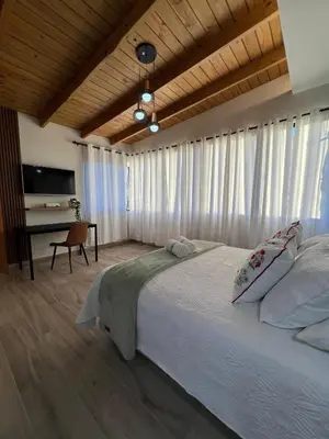 a bedroom with a large bed and a desk at Azotea Quinta Galarza