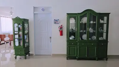a green cabinet next to another green cabinet with dishes at Casa campo Ana Victoria