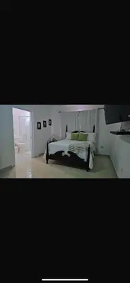 a bedroom with a white bed with green pillows at Casa campo Ana Victoria