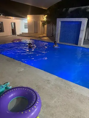 a group of people swimming in a large swimming pool at Casa campo Ana Victoria
