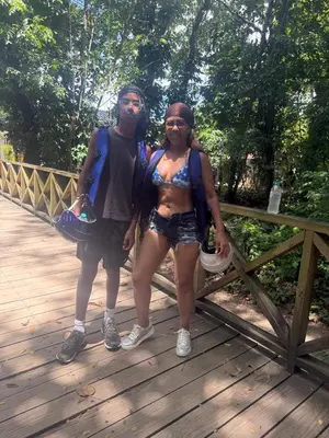 a man and a woman standing on a wooden bridge at Casa campo Ana Victoria