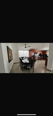 a dining room and living room with a table and chairs at Casa campo Ana Victoria