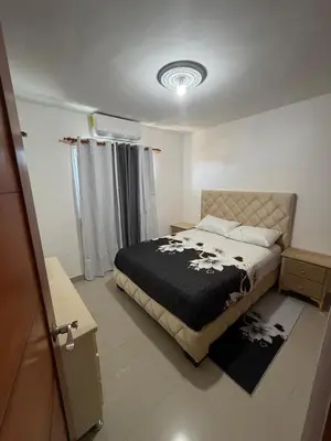 a bedroom with a bed with a black blanket at Apartamento de lujos Avenida España