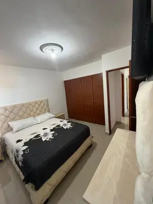 a bedroom with a bed with a black and white blanket at Apartamento de lujos Avenida España