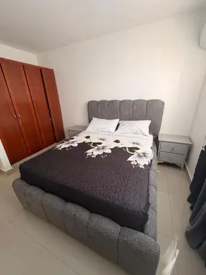 a bed in a small room with a bedskirtspectspectssenalsenalsenalsenal at Apartamento de lujos Avenida España