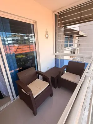 a balcony with two chairs and a window at Santo domingo Avenida España