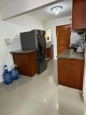 a kitchen with a stainless steel refrigerator and a counter at Santo domingo Avenida España