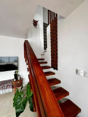 a wooden staircase in a living room with at Penthouse with Jacuzzi Near Beach in Las Terrenas