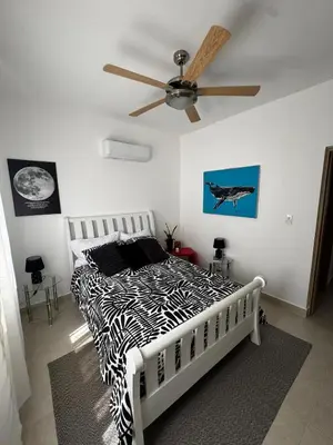 a zebra print bed in a bedroom with a ceiling fan at Penthouse with Jacuzzi Near Beach in Las Terrenas