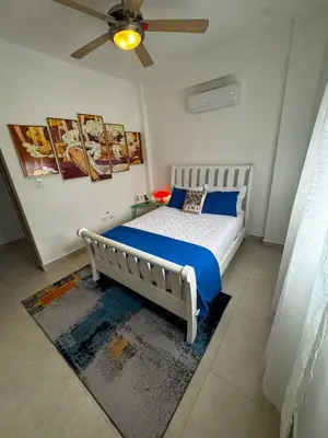 a bedroom with a bed and a ceiling fan at Penthouse with Jacuzzi Near Beach in Las Terrenas