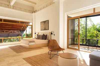 a bedroom with a bed and a large window at Luxury 3BR Penthouse in Casa de Campo, Gated Resort Living & Golf View in La Romana