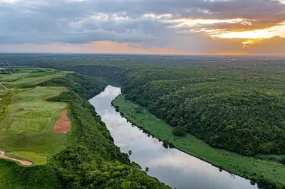 an aerial view of a river with trees and a field at Luxury 3BR Penthouse in Casa de Campo, Gated Resort Living & Golf View in La Romana