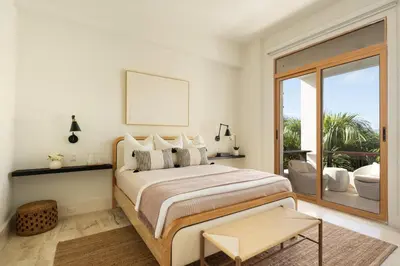 a bedroom with a large bed and a balcony at Luxury 3BR Penthouse in Casa de Campo, Gated Resort Living & Golf View in La Romana