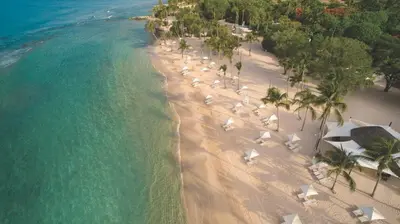 an aerial view of a beach with umbrellas and the ocean at Luxury 3BR Penthouse in Casa de Campo, Gated Resort Living & Golf View in La Romana