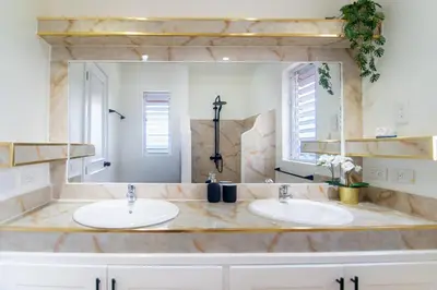 a bathroom with two sinks and a large mirror at Villa Bella Vista - Luxury Ocean View and Private Pool, Las Terrenas in Las Terrenas