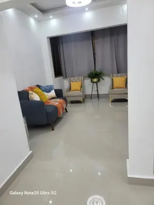 a living room with a couch and two chairs at Colonial suites in Santo Domingo