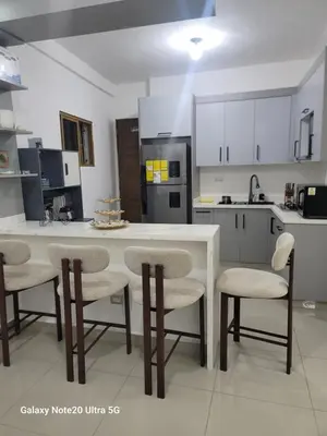 a kitchen with a table and chairs and a counter at Colonial suites in Santo Domingo