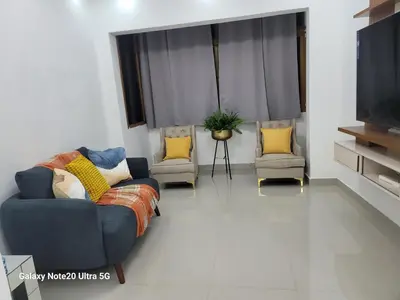 a living room with a couch and two chairs at Colonial suites in Santo Domingo