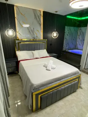 a bedroom with a large bed with two towels on it at Luxury and beautiful studio private jacuzzi in Santo Domingo