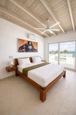 a bedroom with a large bed and a large window at Sunset Calm Penthouse in Cabarete