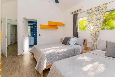 a bedroom with two beds and a window at Villa Ocean Dream 3BR Oasis and guesthouse in Sosúa