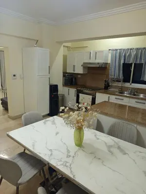 a kitchen with a table with a vase of flowers on it at Torre chalom in Santo Domingo