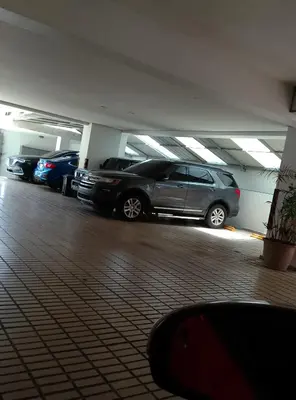 a parking lot with cars parked in a parking garage at Torre shalom in Santo Domingo