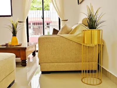 a living room with a couch and a table at Padres Las Casa in Santiago de los Caballeros