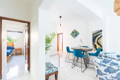 a living room and dining room with a table and chairs at Coastal Corner -Beach-Pool-Terrace-Parking-Pets in Villas del Mar