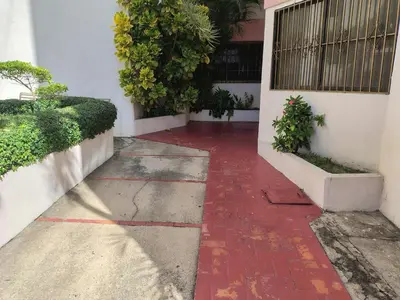 a red brick walkway in front of a building at Comfortable and quiet single room in Santo Domingo
