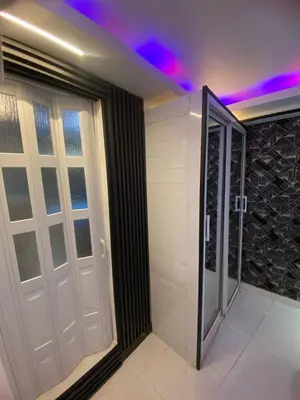 a bathroom with a door and a walk in shower at Luxury Beautiful mini apartment Private jacuzzi in Santo Domingo