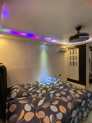 a bedroom with a bed with a colorful blanket at Luxury Beautiful mini apartment Private jacuzzi in Santo Domingo