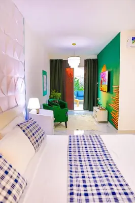 a bedroom with a bed and a living room at Agapimou apartments H in Gaspar Hernández