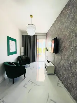 a living room with a couch and a chair at Agapimou apartments H in Gaspar Hernández