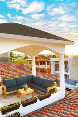 a blue couch under a pavilion on a roof at Agapimou apartments H in Gaspar Hernández