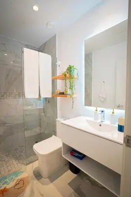a bathroom with a sink and a toilet and a shower at Golf View Penthouse with Private Rooftop & BBQ in Punta Cana
