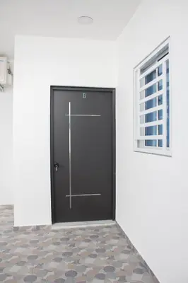 a black door in a white room with a window at Apartamentos carrasco in Nagua