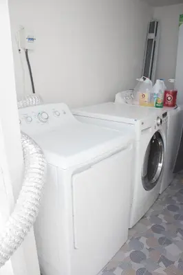 a white washer and dryer in a room at Apartamentos carrasco in Nagua