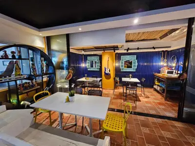 a restaurant with a white table and yellow chairs at Apartamento frente al Mar y Piscina in Juan Dolio